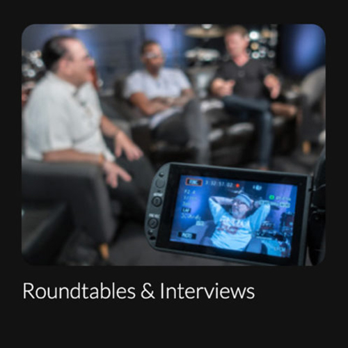 Image of four guys being filmed and sitting in couches for a roundtable interview.