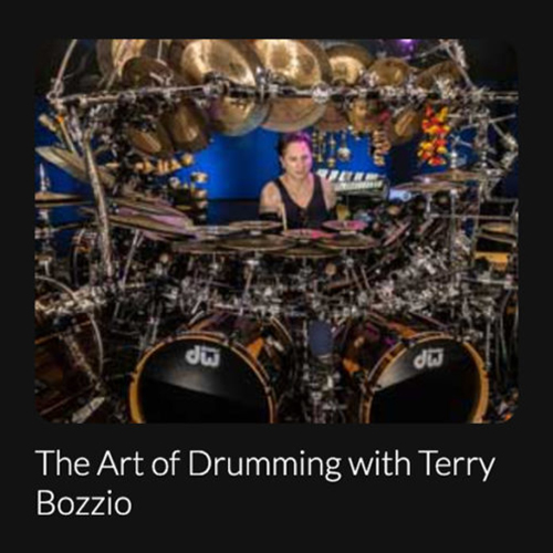 Image of Terry Bozzio sitting at a large drum kit.